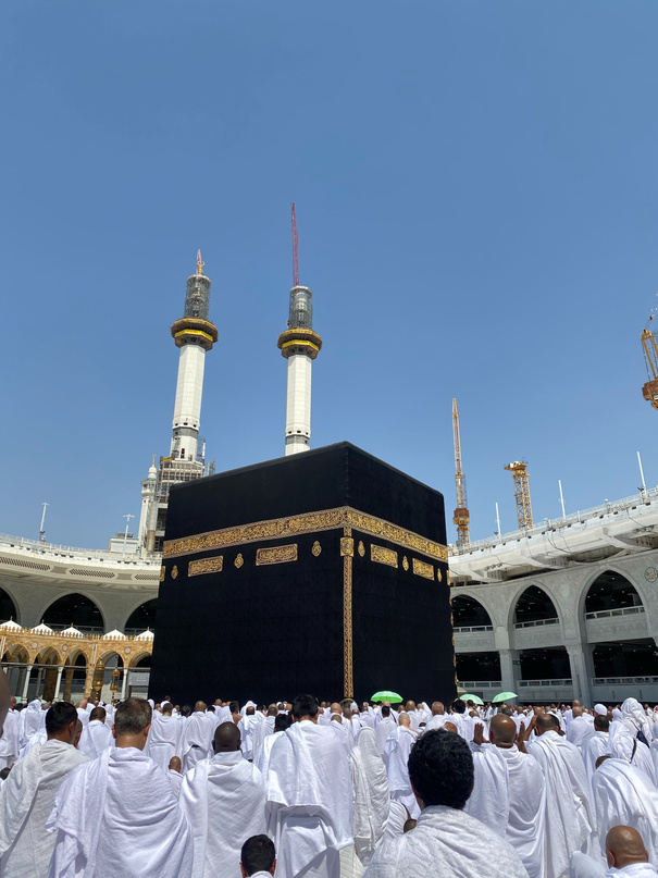 People in white robes standing around the kaaba